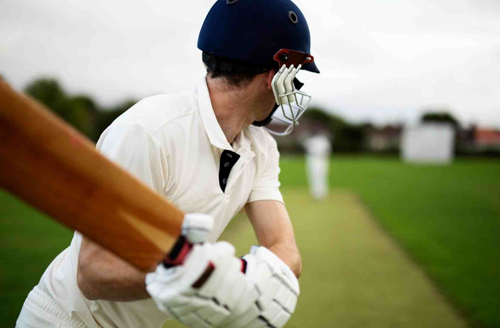 Cricket batter preparing to play a shot on the pitch